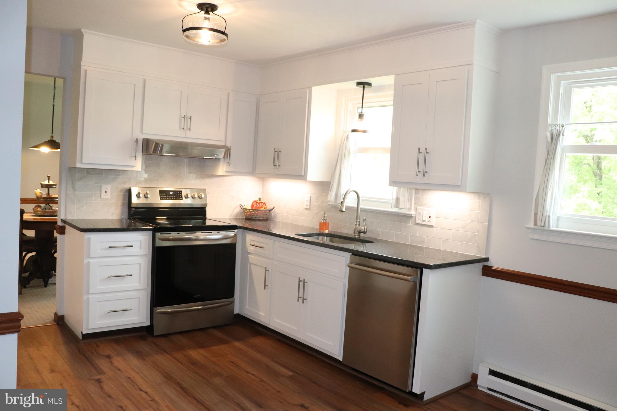 2181 School Road Pottstown, PA 19465 - Photo 11 of 42 a kitchen with granite countertop a sink and a stove top oven