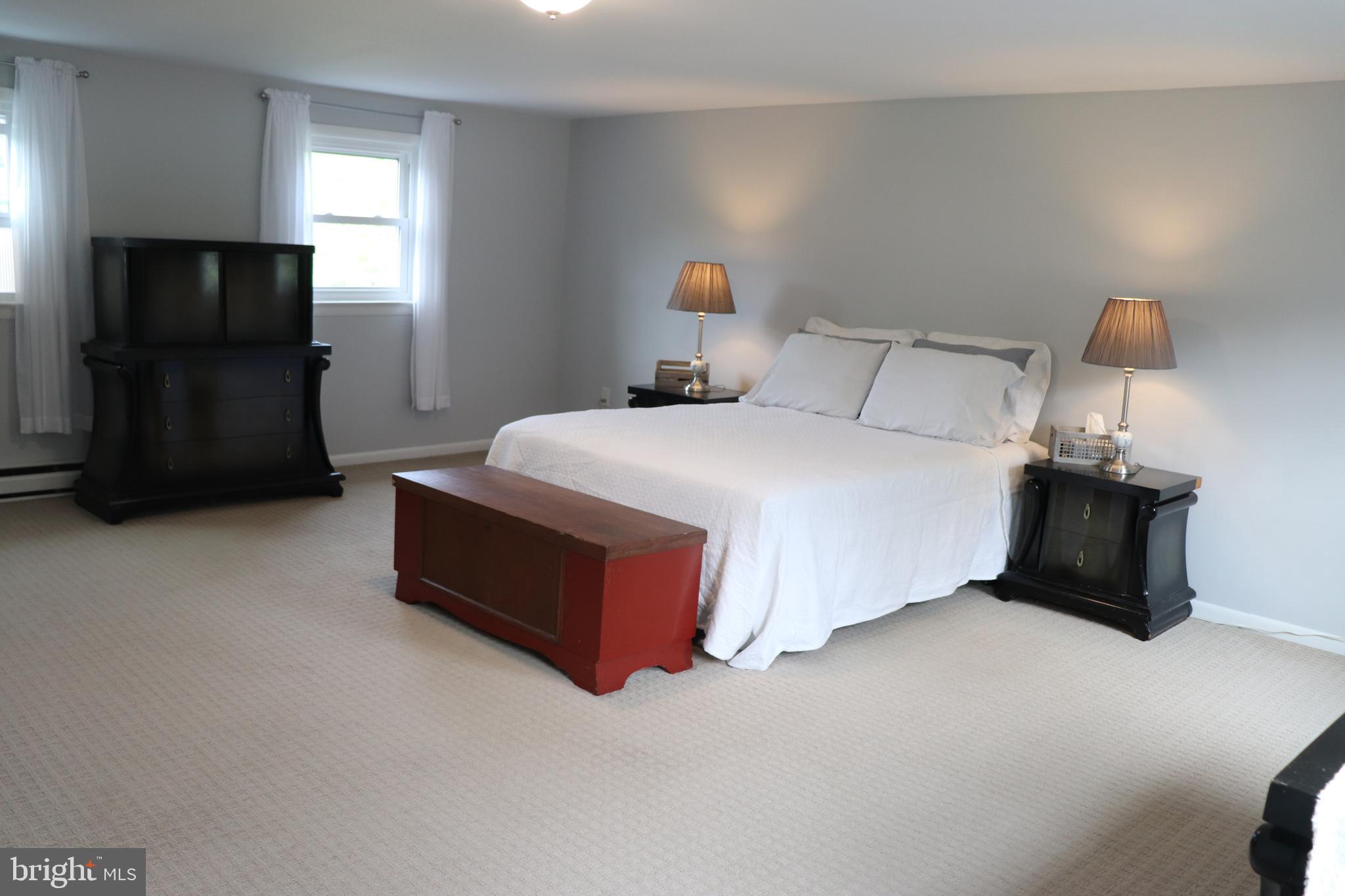 2181 School Road Pottstown, PA 19465 - Photo 21 of 42 a spacious bedroom with a bed and a television in it