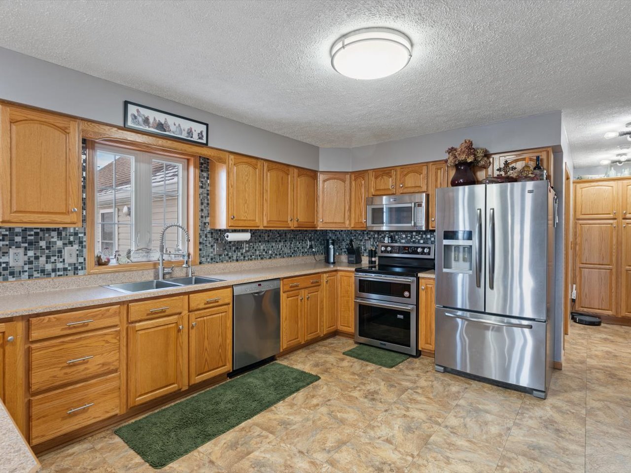 2572 160th Avenue Aledo, IL 61231 - Photo 27 of 66 a kitchen with granite countertop stainless steel appliances a stove sink and refrigerator