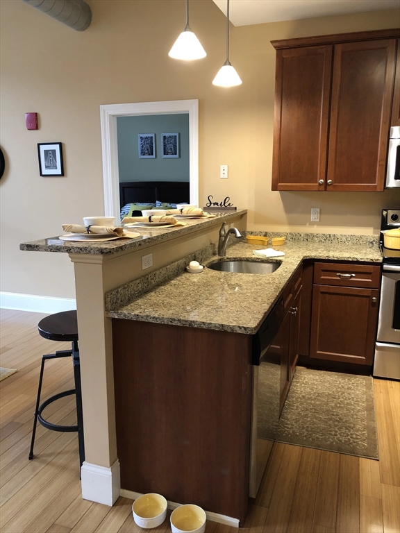 55 Green Street, Unit D139 Clinton, MA 01510 - Photo 4 of 18 a kitchen with a sink cabinets and wooden floor