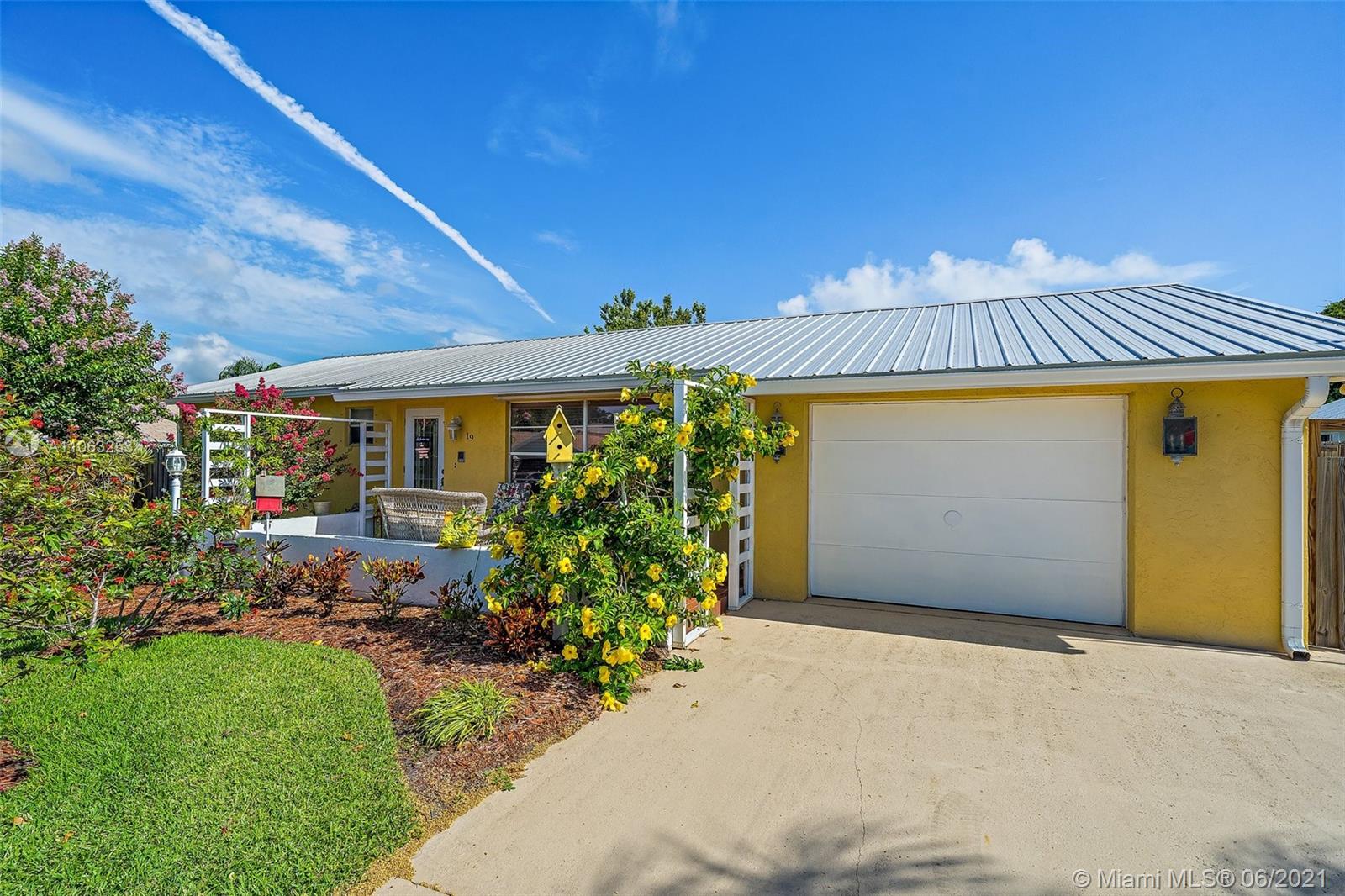 19 Shay Place Tequesta, FL 33469 - Photo 2 of 54 a front view of a house with garden