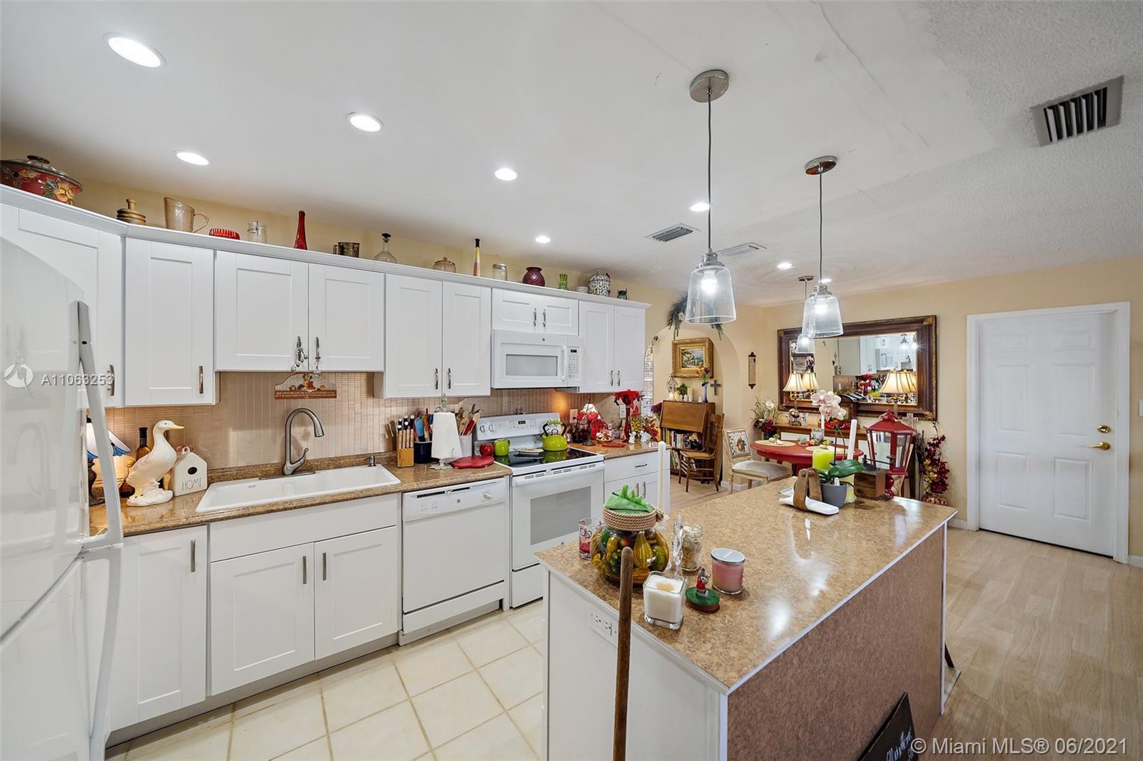 19 Shay Place Tequesta, FL 33469 - Photo 12 of 54 a view of kitchen and sink with cabinets