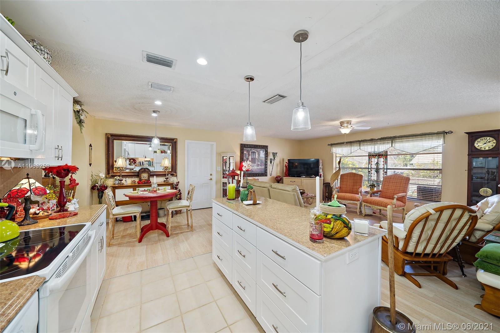 19 Shay Place Tequesta, FL 33469 - Photo 14 of 54 a group of people sitting in a living room