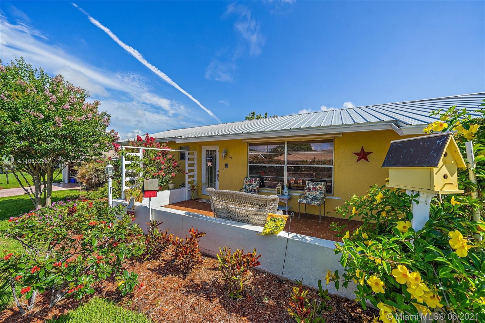 19 Shay Place Tequesta, FL 33469 - Photo 3 of 54 front view of a house with a garden