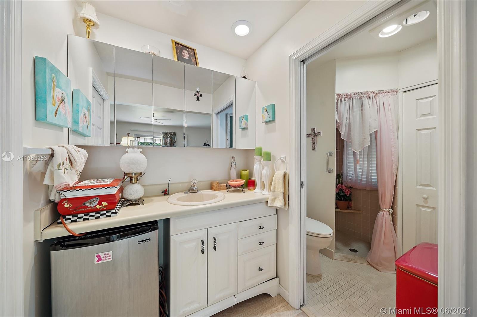 19 Shay Place Tequesta, FL 33469 - Photo 23 of 54 a utility room with cabinets washer and dryer