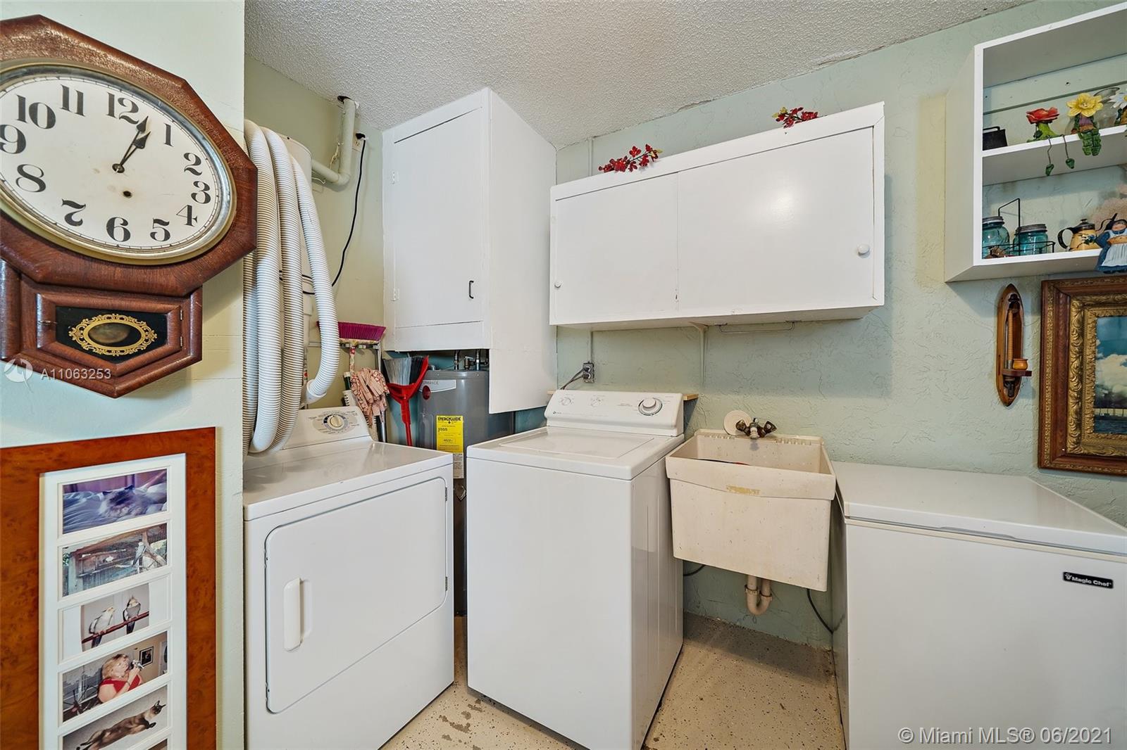19 Shay Place Tequesta, FL 33469 - Photo 31 of 54 a view of a storage and utility room with a washer and dryer