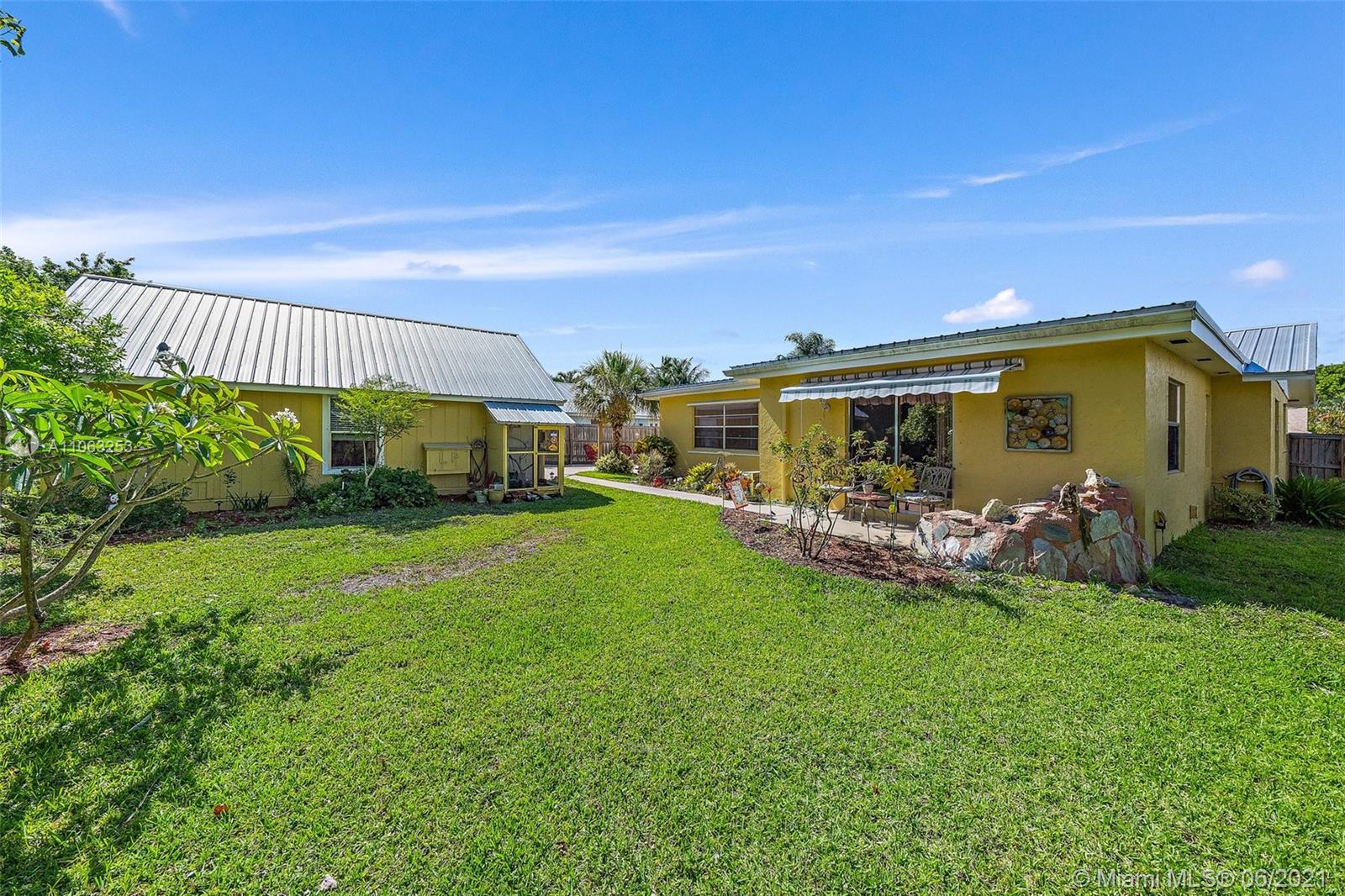 19 Shay Place Tequesta, FL 33469 - Photo 35 of 54 a view of a house with backyard and porch