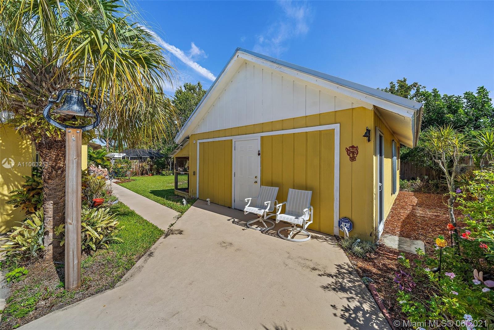 19 Shay Place Tequesta, FL 33469 - Photo 37 of 54 a view of backyard with wheel chair potted plants and large tree