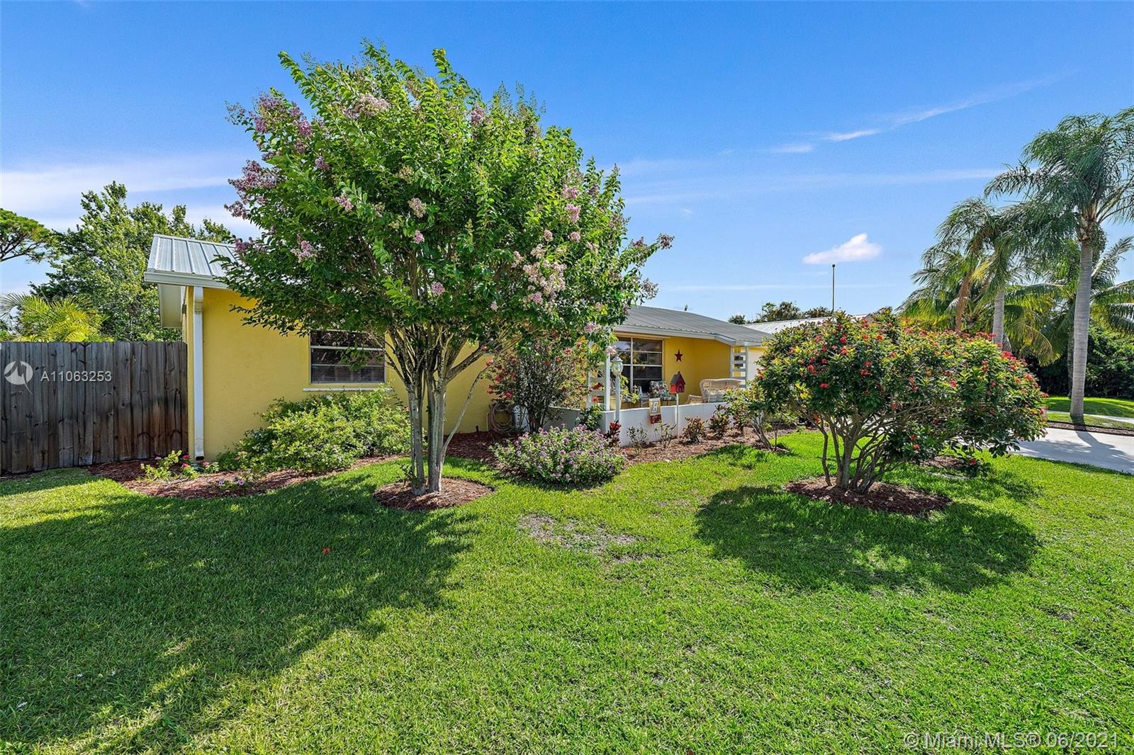 19 Shay Place Tequesta, FL 33469 - Photo 43 of 54 a view of a house with backyard sitting area and garden