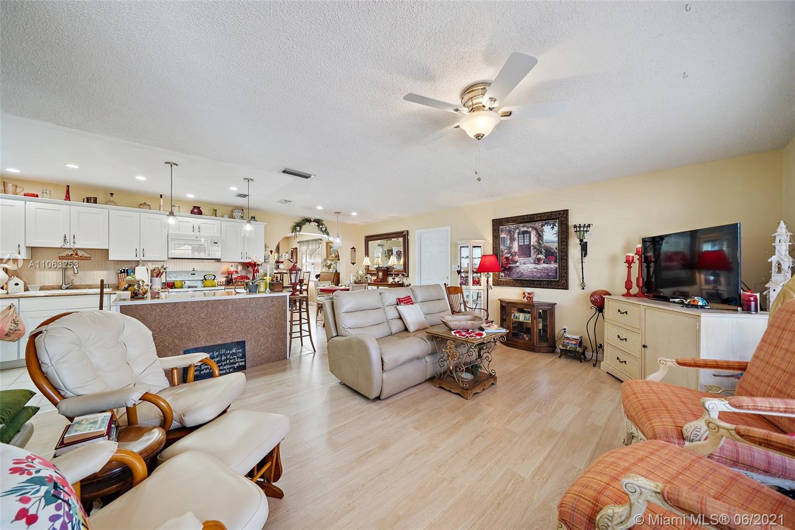 19 Shay Place Tequesta, FL 33469 - Photo 7 of 54 a living room with furniture and a flat screen tv