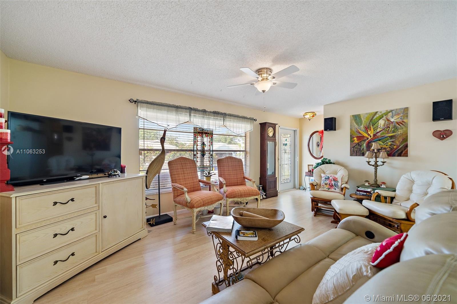 19 Shay Place Tequesta, FL 33469 - Photo 9 of 54 a living room with furniture and a flat screen tv