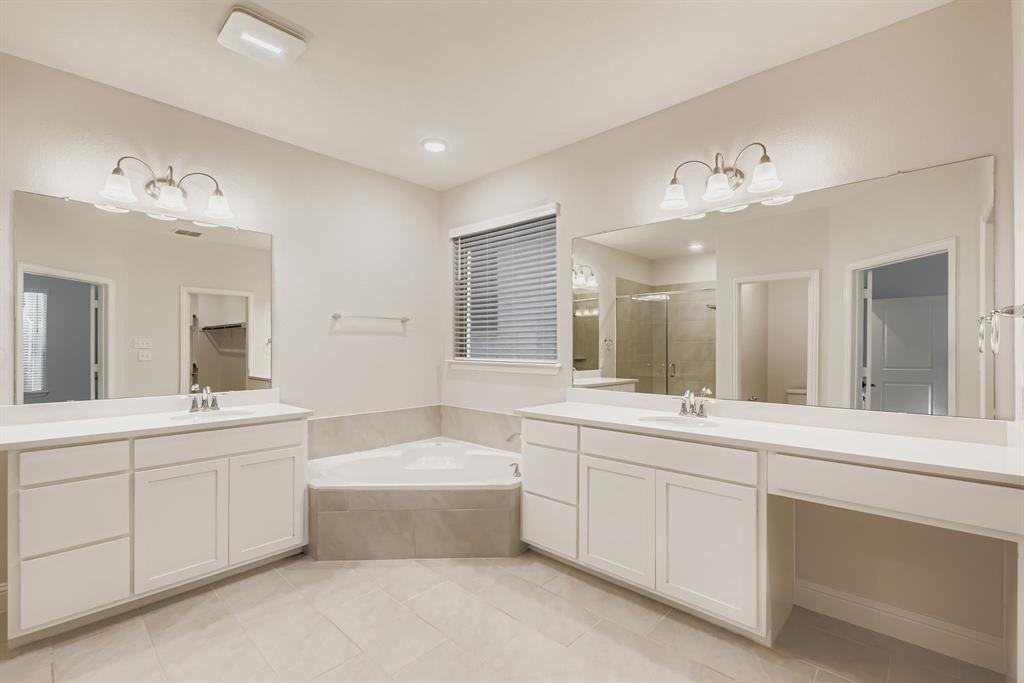 312 Magnolia Drive Oak Point, TX 75068 - Photo 14 of 28 Full bathroom with a shower stall, a garden tub, light tile patterned floors, and two vanities