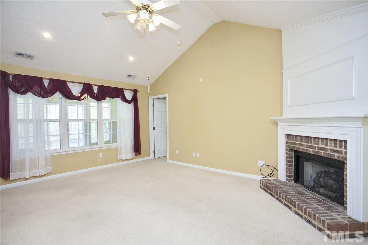 4513 Drewbridge Way Raleigh, NC 27604 - Photo 8 of 25 a view of an empty room with a fireplace and a window