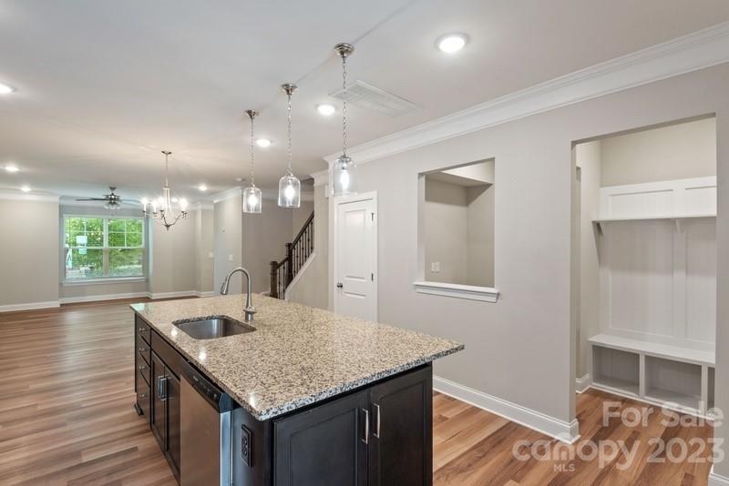 208 Waterlynn Ridge Road, Unit D Mooresville, NC 28117 - Photo 11 of 23 a kitchen with a kitchen island a sink appliances and a living room