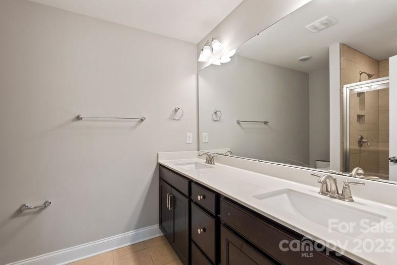 208 Waterlynn Ridge Road, Unit D Mooresville, NC 28117 - Photo 19 of 23 a bathroom with a granite countertop sink and a mirror