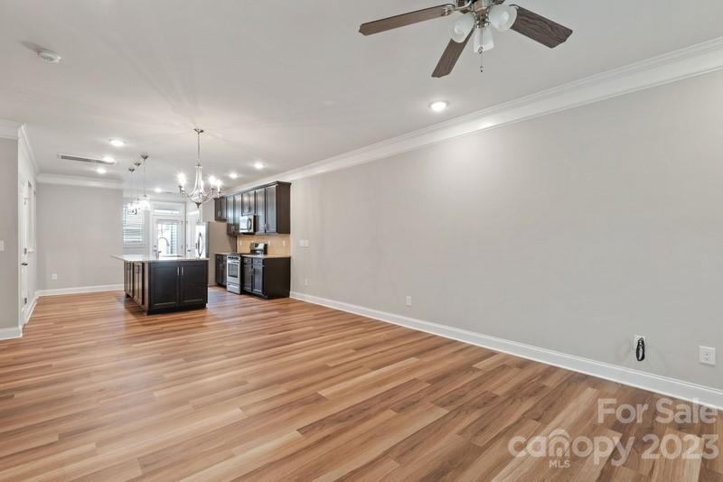 208 Waterlynn Ridge Road, Unit D Mooresville, NC 28117 - Photo 5 of 23 a view of a room with a chandelier and wooden floor