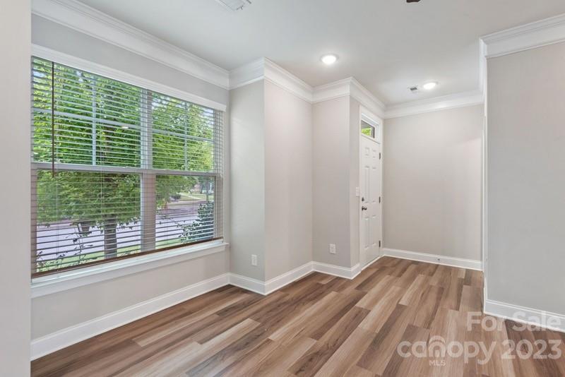 208 Waterlynn Ridge Road, Unit D Mooresville, NC 28117 - Photo 6 of 23 a view of a room with wooden floor and window