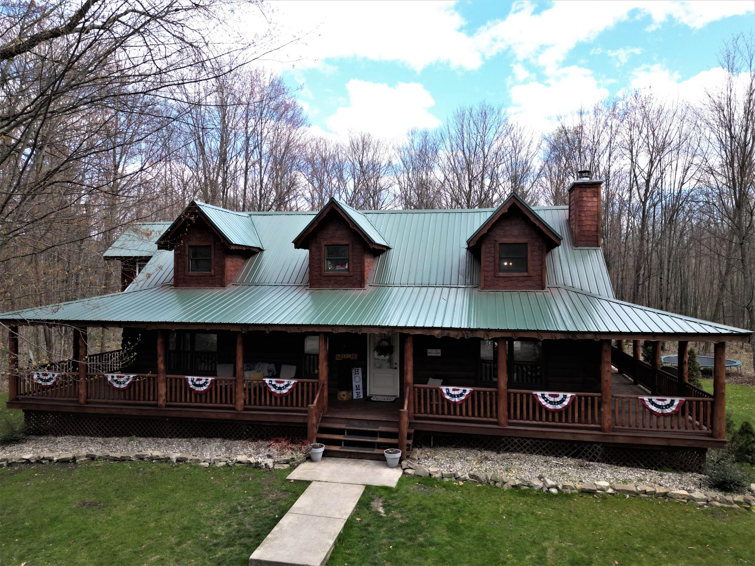 22378 2 Mile Road Morley, MI 49336 - Photo 2 of 26 22375 2 Mile Rd Front Clint Maki Log Hom