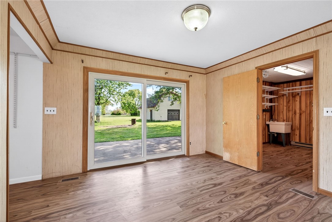1005 Free Road New Carlisle, OH 45344 - Photo 11 of 43 This versatile room features durable flooring and direct outdoor access, perfect for functional living.