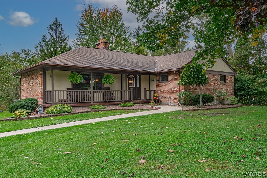 A classic brick exterior and covered front porch define this inviting single-story home.
