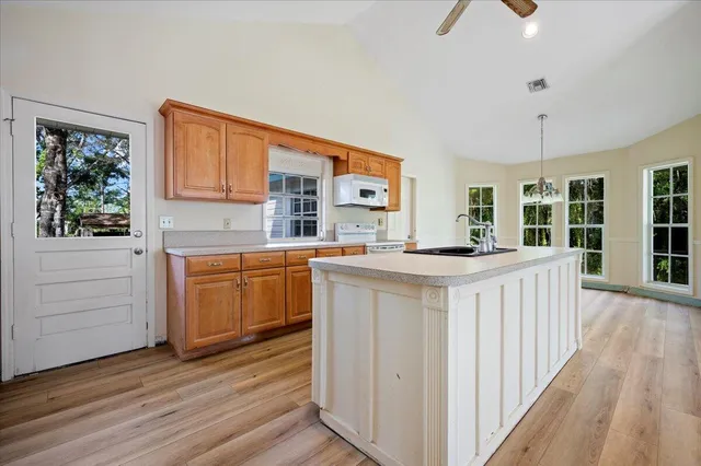 a kitchen with counter top space and wooden floor