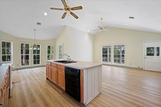 a kitchen with a stove and wooden floor