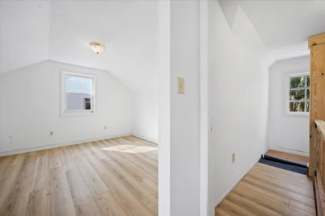 a view of a room with wooden floor and a window