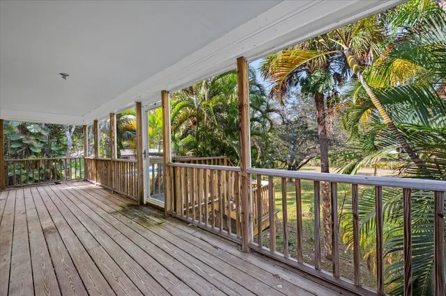 a view of a wooden fence and trees