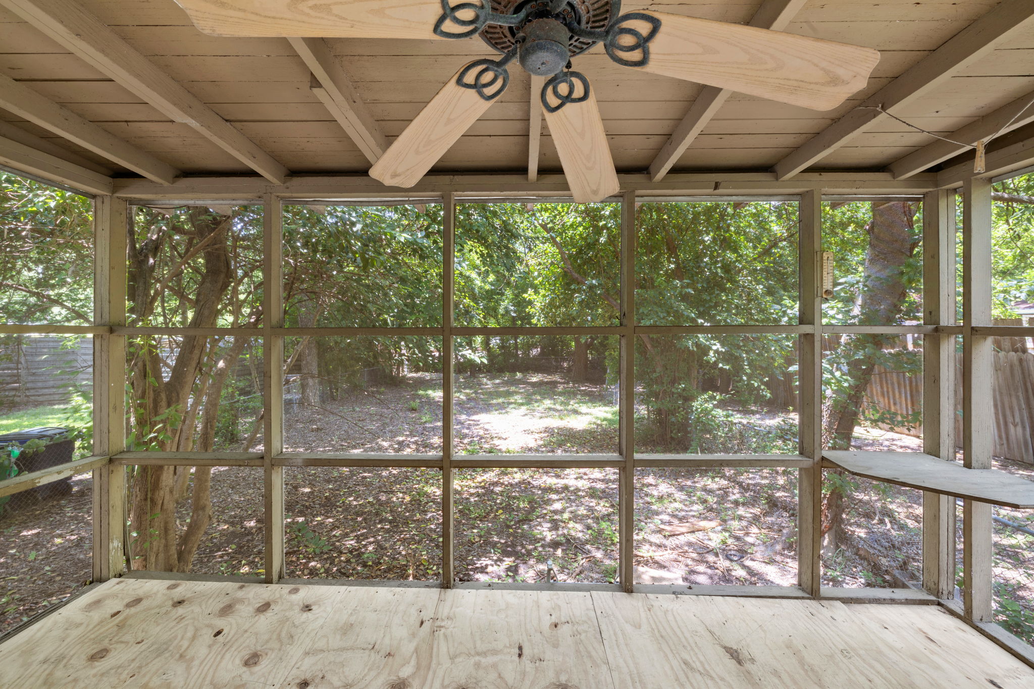 3704 Cherrywood Road Austin, TX 78722 - Photo 32 of 40 Enjoy nature's embrace from this screened porch with a beautiful backyard view.