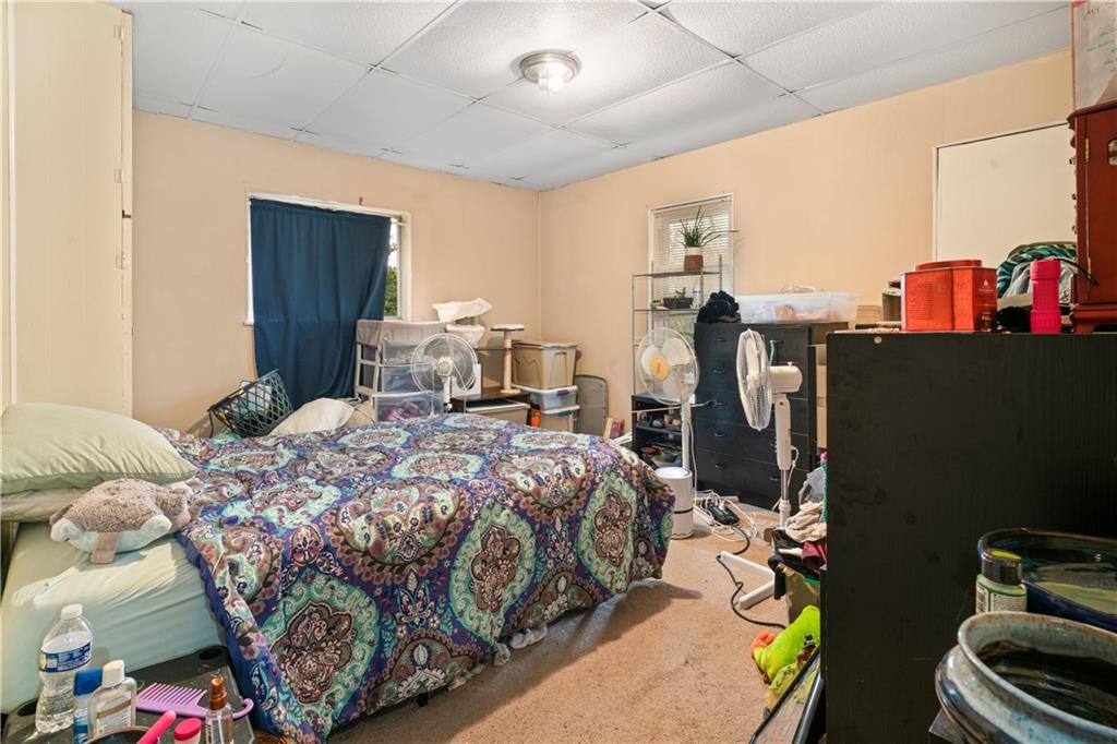 7709 Juniata Street Pittsburgh, PA 15218 - Photo 14 of 22 a bedroom with a bed and a tv