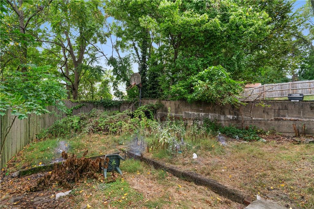 7709 Juniata Street Pittsburgh, PA 15218 - Photo 19 of 22 a view of a garden with a bench and some trees