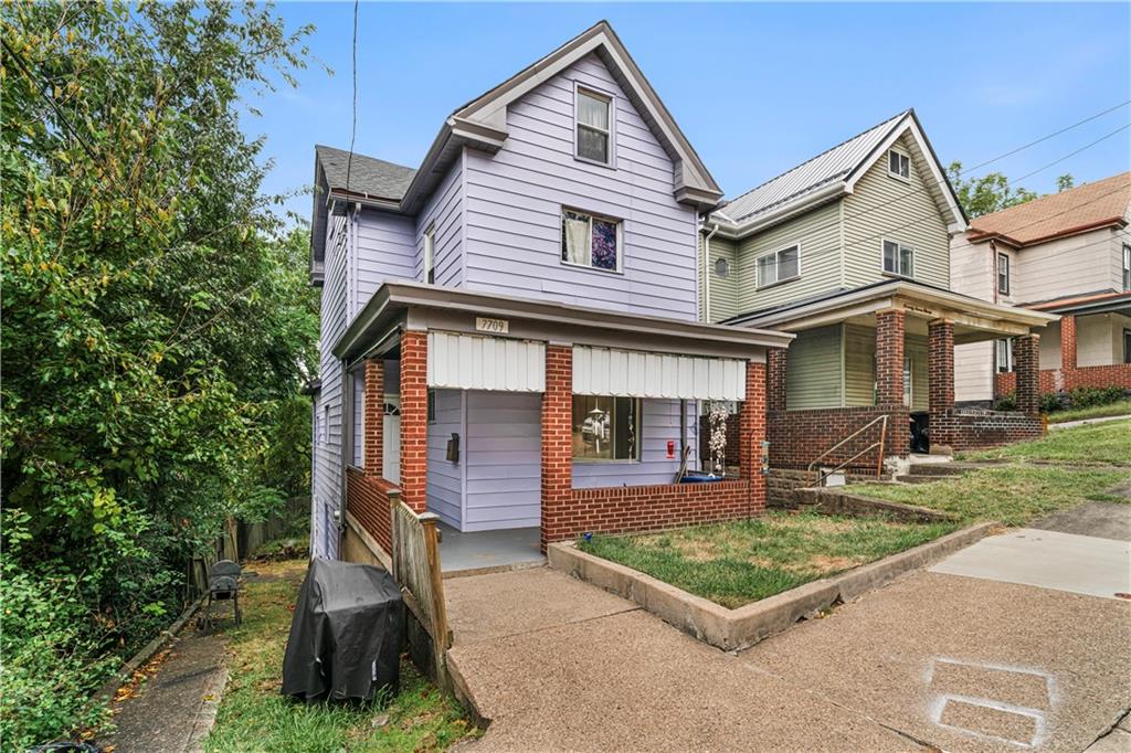 7709 Juniata Street Pittsburgh, PA 15218 - Photo 2 of 22 a front view of a house with garden