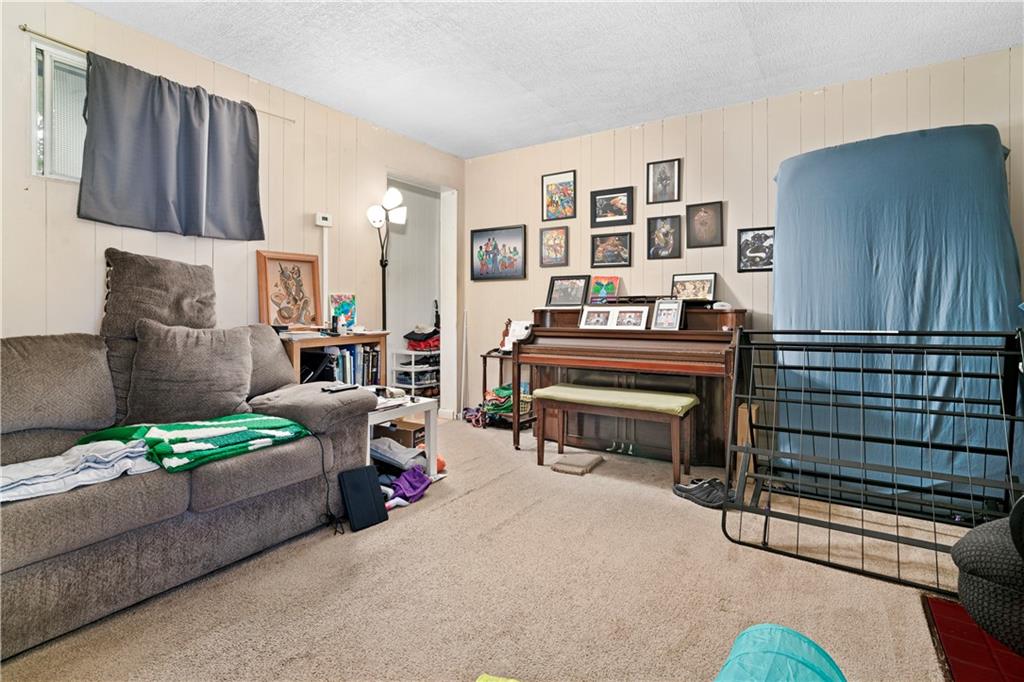 7709 Juniata Street Pittsburgh, PA 15218 - Photo 6 of 22 a bedroom with furniture and a lamp