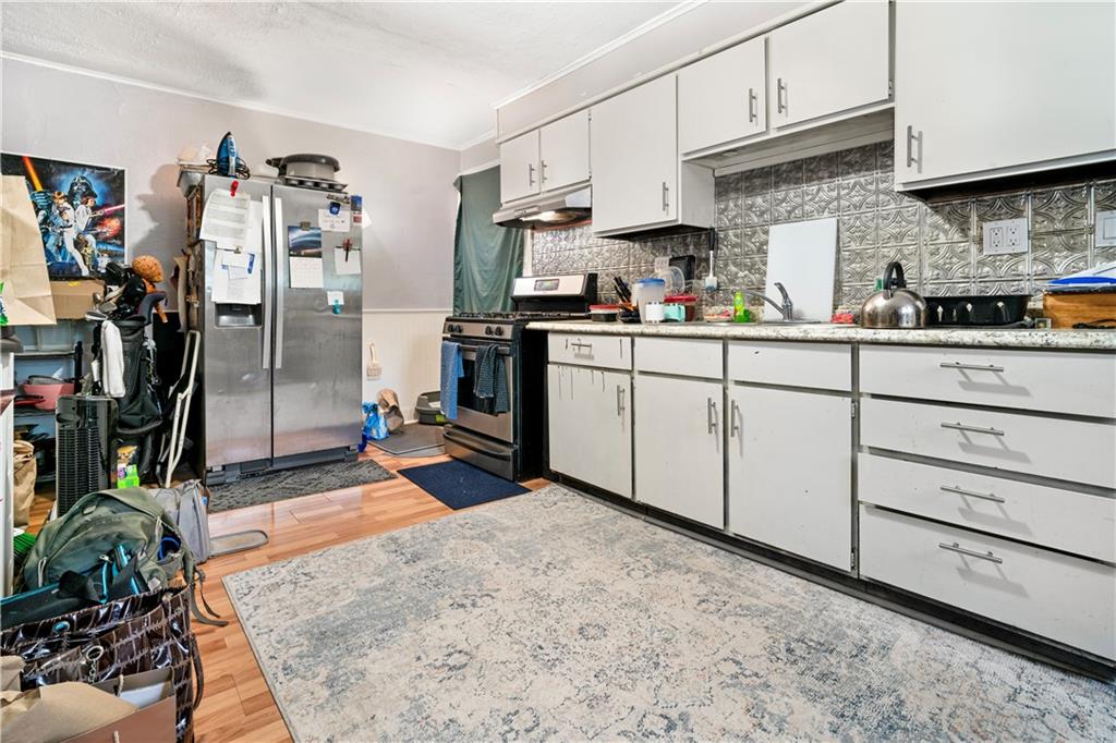 7709 Juniata Street Pittsburgh, PA 15218 - Photo 8 of 22 a kitchen with stainless steel appliances granite countertop a refrigerator and a stove top oven