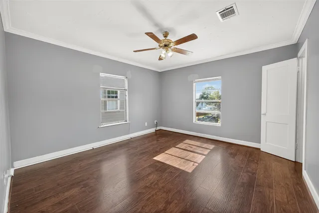 wooden floor in an empty room with a window