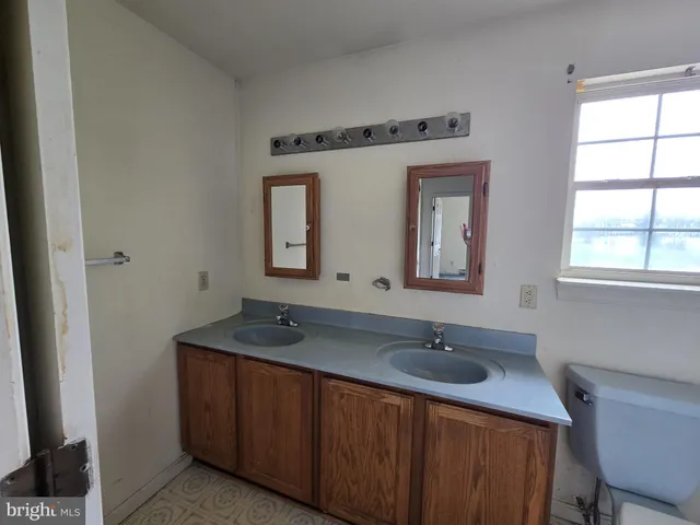 a bathroom with a sink a mirror and a window
