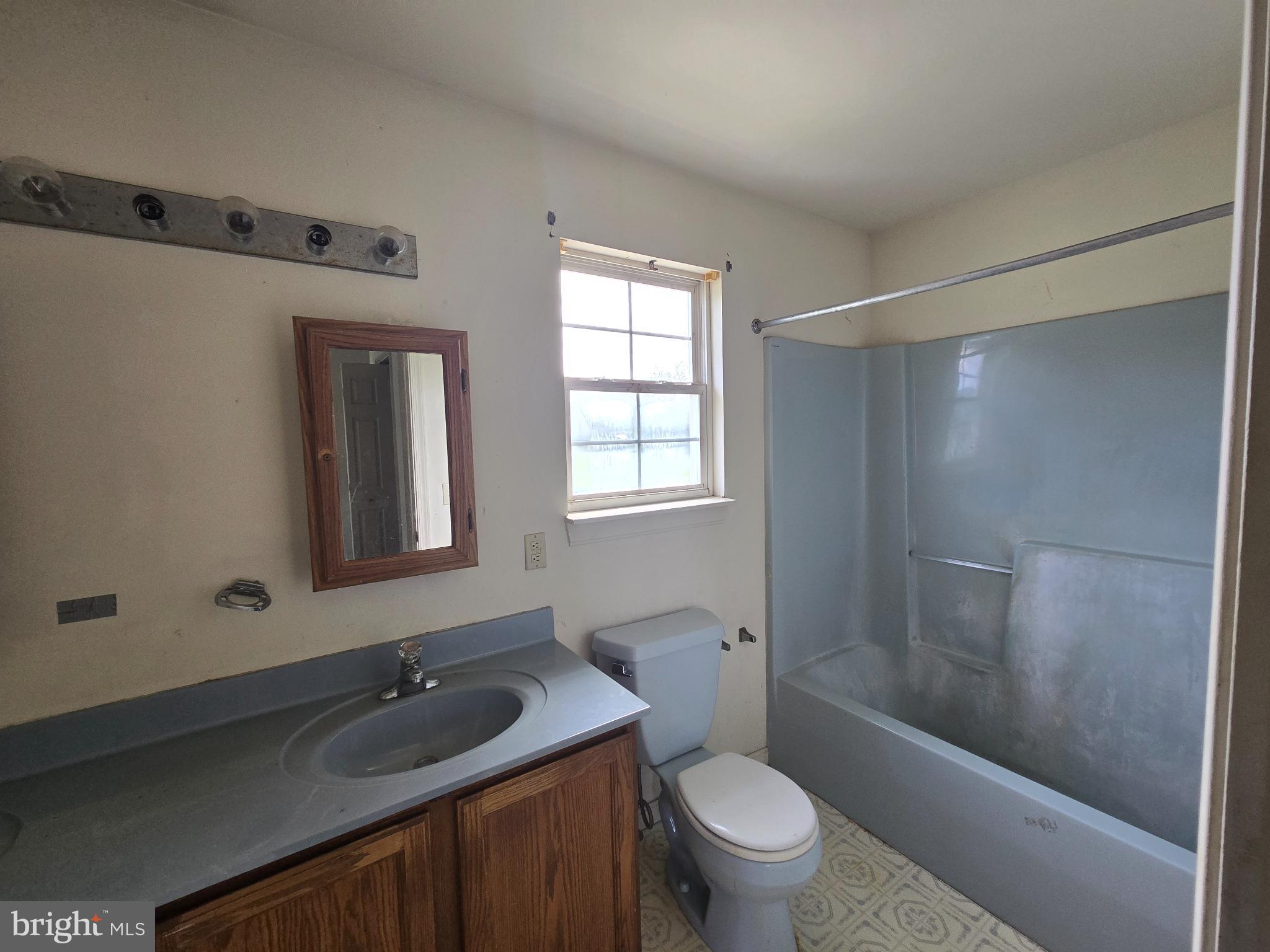8806 Greentop Road Lincoln, DE 19960 - Photo 29 of 35 a bathroom with a granite countertop sink toilet and shower