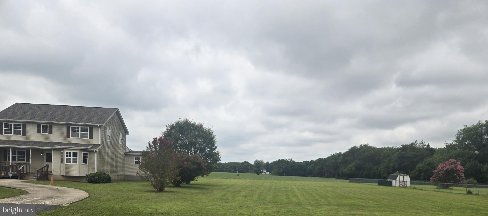 8806 Greentop Road Lincoln, DE 19960 - Photo 7 of 35 a view of a big house with a big yard and a fountain