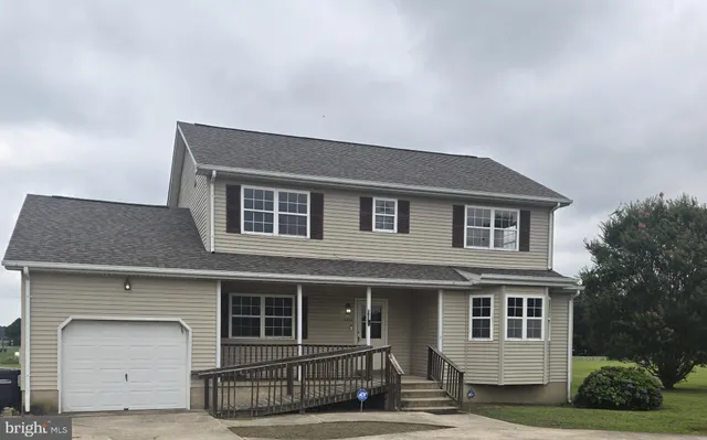 a front view of a house with garage