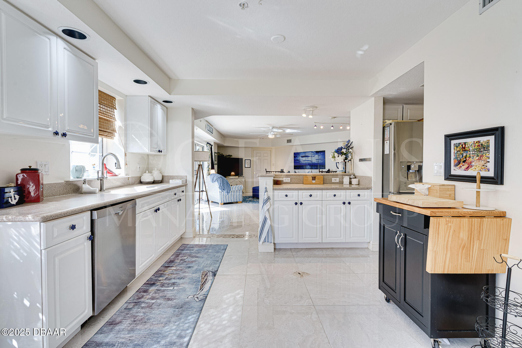 4650 Links Village Drive, Unit C303 Ponce Inlet, FL 32127 - Photo 12 of 67 a kitchen with counter top space cabinets and stainless steel appliances