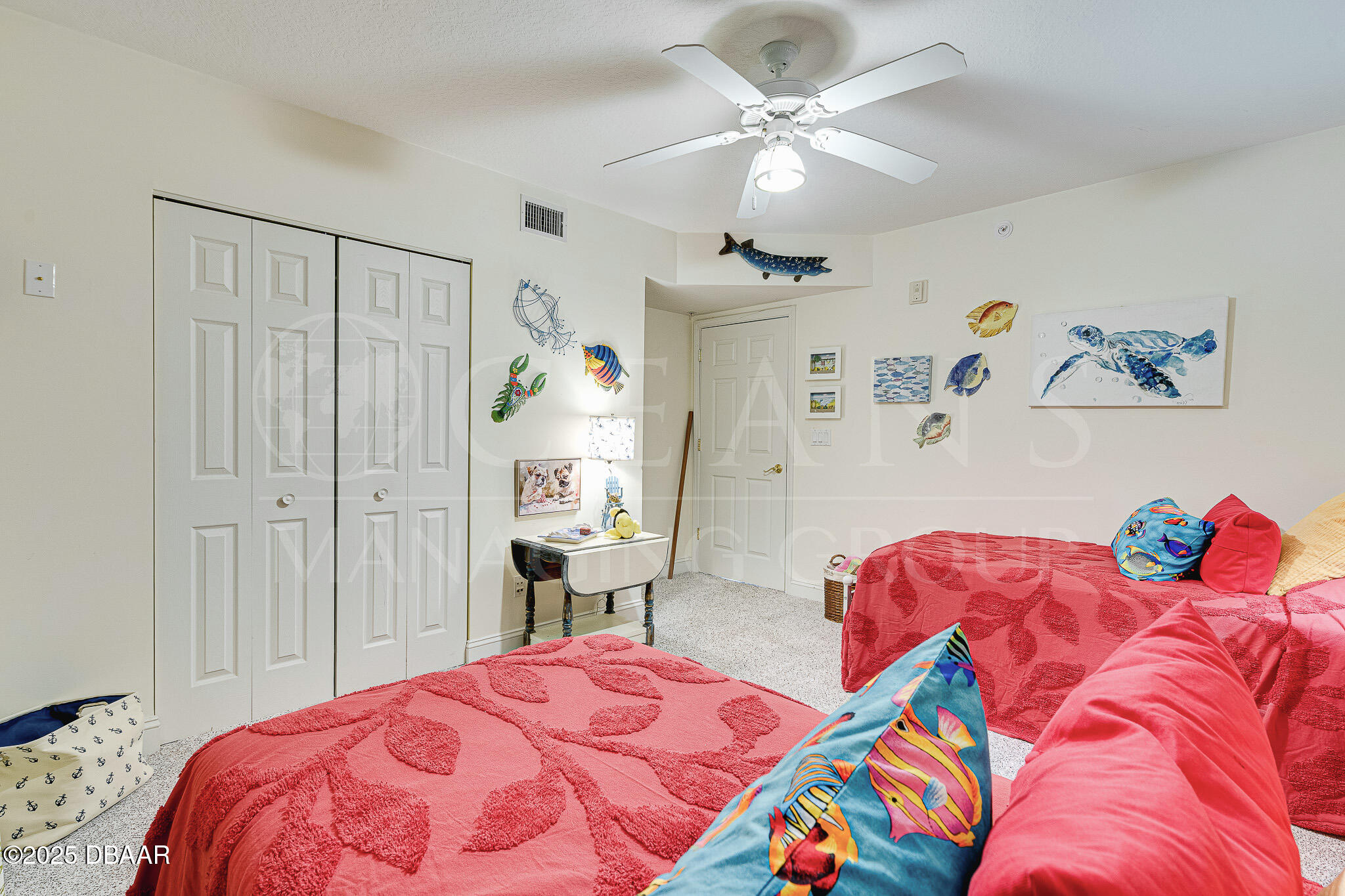 4650 Links Village Drive, Unit C303 Ponce Inlet, FL 32127 - Photo 15 of 67 a bedroom with a bed and a chandelier