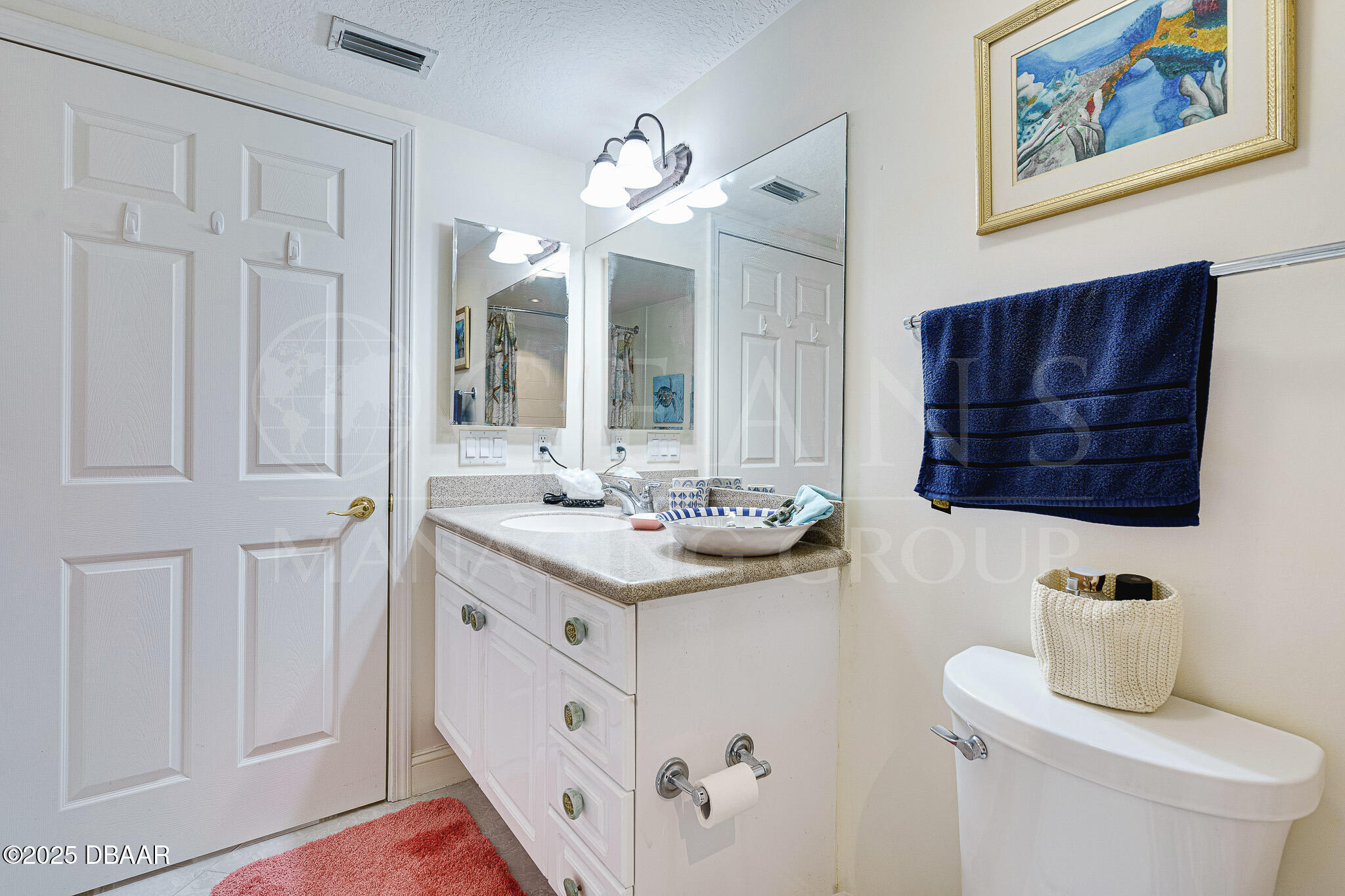 4650 Links Village Drive, Unit C303 Ponce Inlet, FL 32127 - Photo 17 of 67 a bathroom with a sink vanity and mirror