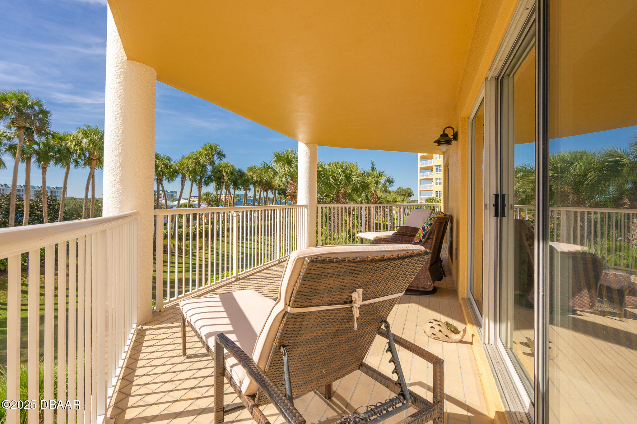 4650 Links Village Drive, Unit C303 Ponce Inlet, FL 32127 - Photo 34 of 67 a view of balcony with wooden floor and outdoor seating