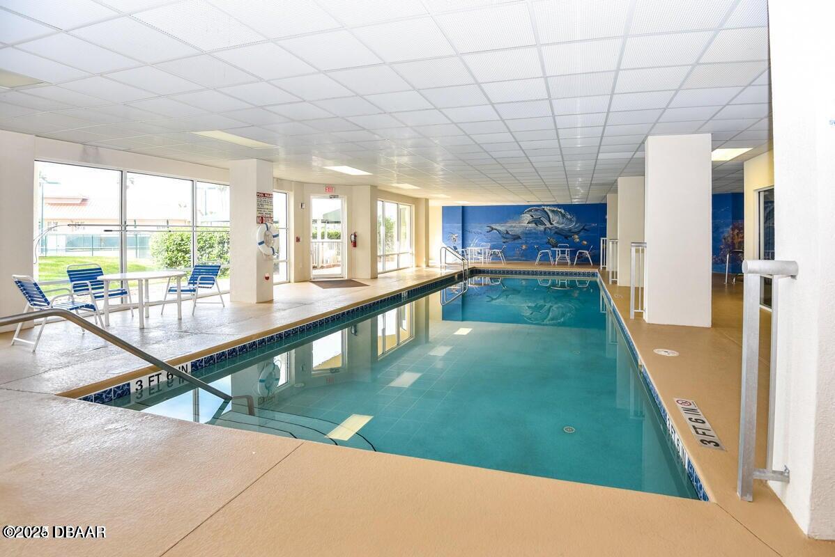 4650 Links Village Drive, Unit C303 Ponce Inlet, FL 32127 - Photo 38 of 67 a very nice looking dining room with a large window with kitchen view