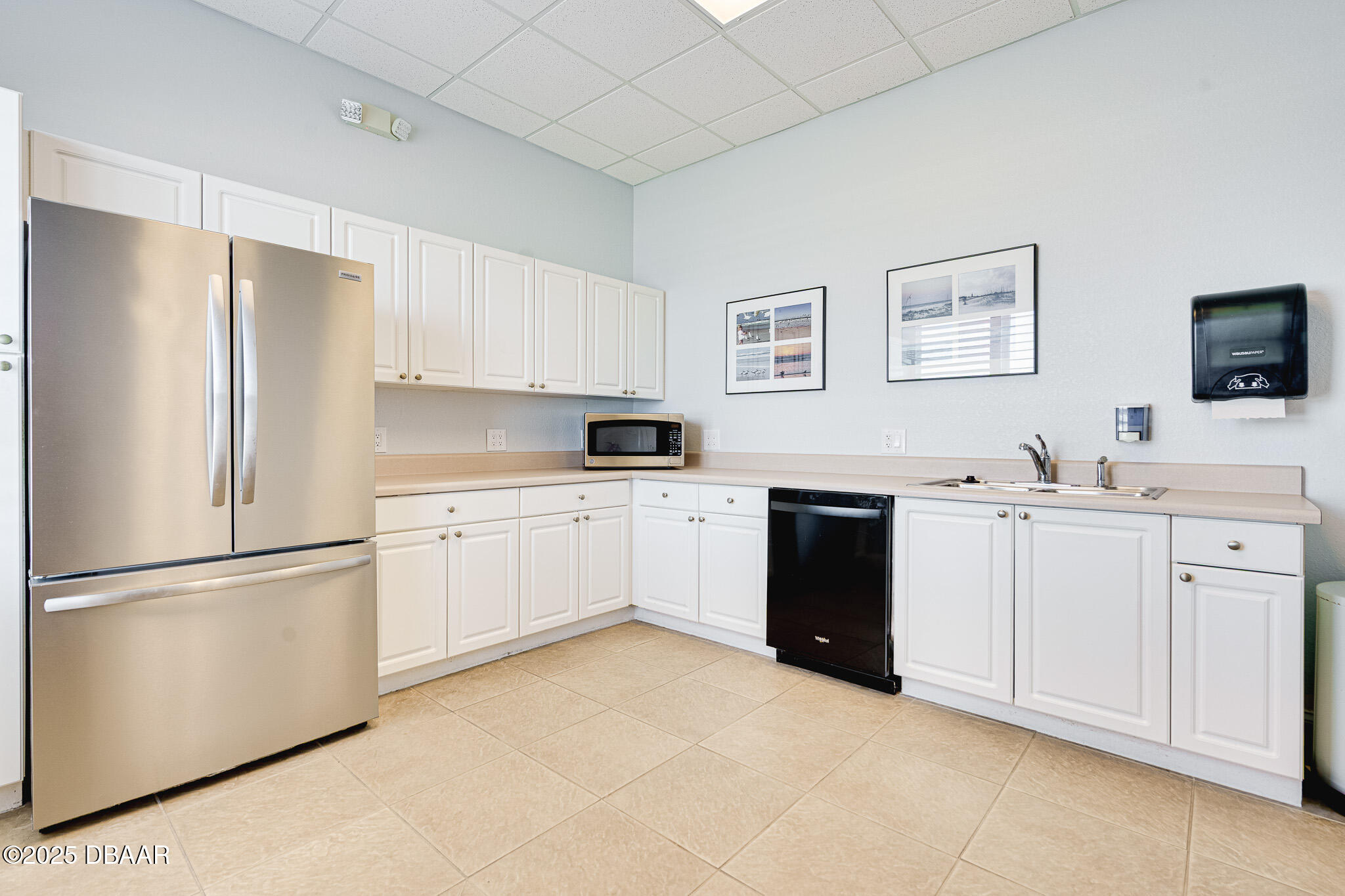 4650 Links Village Drive, Unit C303 Ponce Inlet, FL 32127 - Photo 58 of 67 a kitchen with white cabinets and white appliances