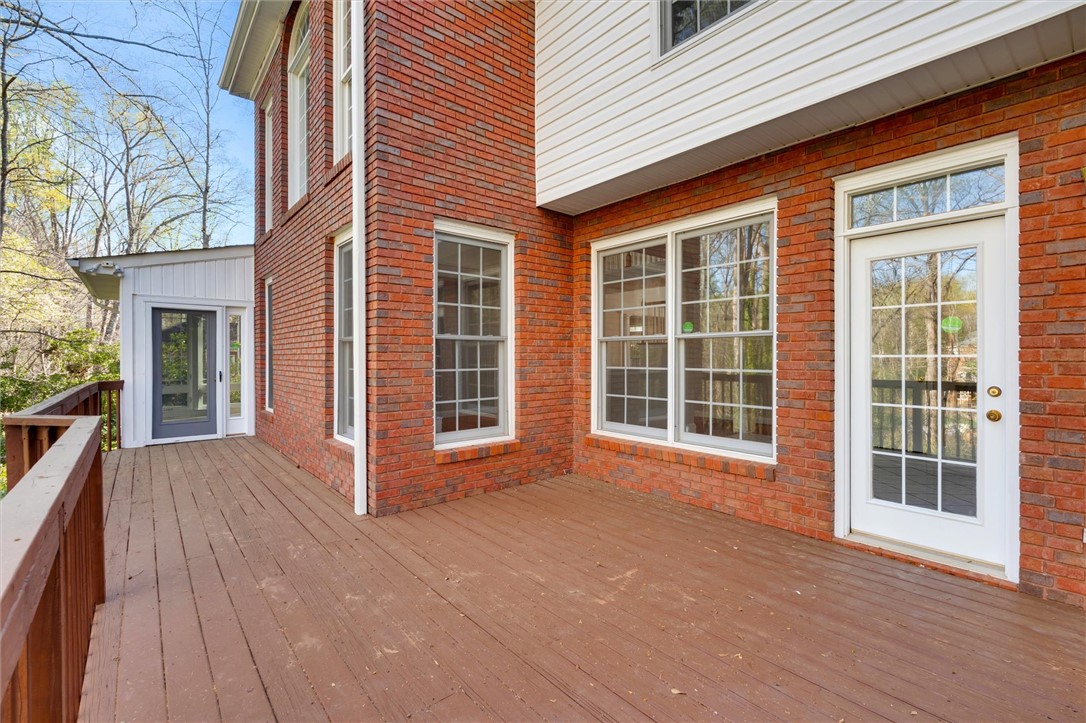 204 Red Maple Way Clemson, SC 29631 - Photo 41 of 48 This spacious wooden deck extends from a brick-sided home, perfect for outdoor enjoyment.