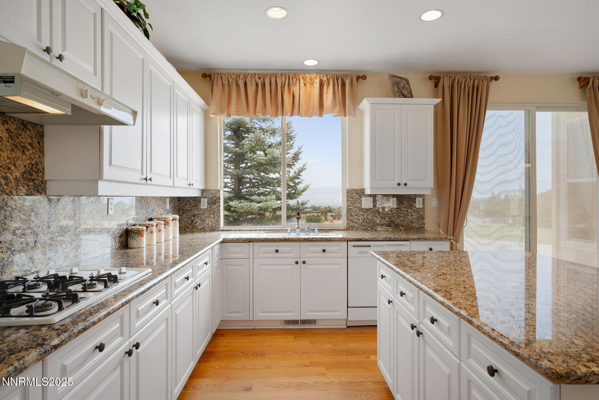 3206 Old Coach Court Reno, NV 89511 - Photo 19 of 40 a kitchen with stainless steel appliances granite countertop a stove a sink and a refrigerator