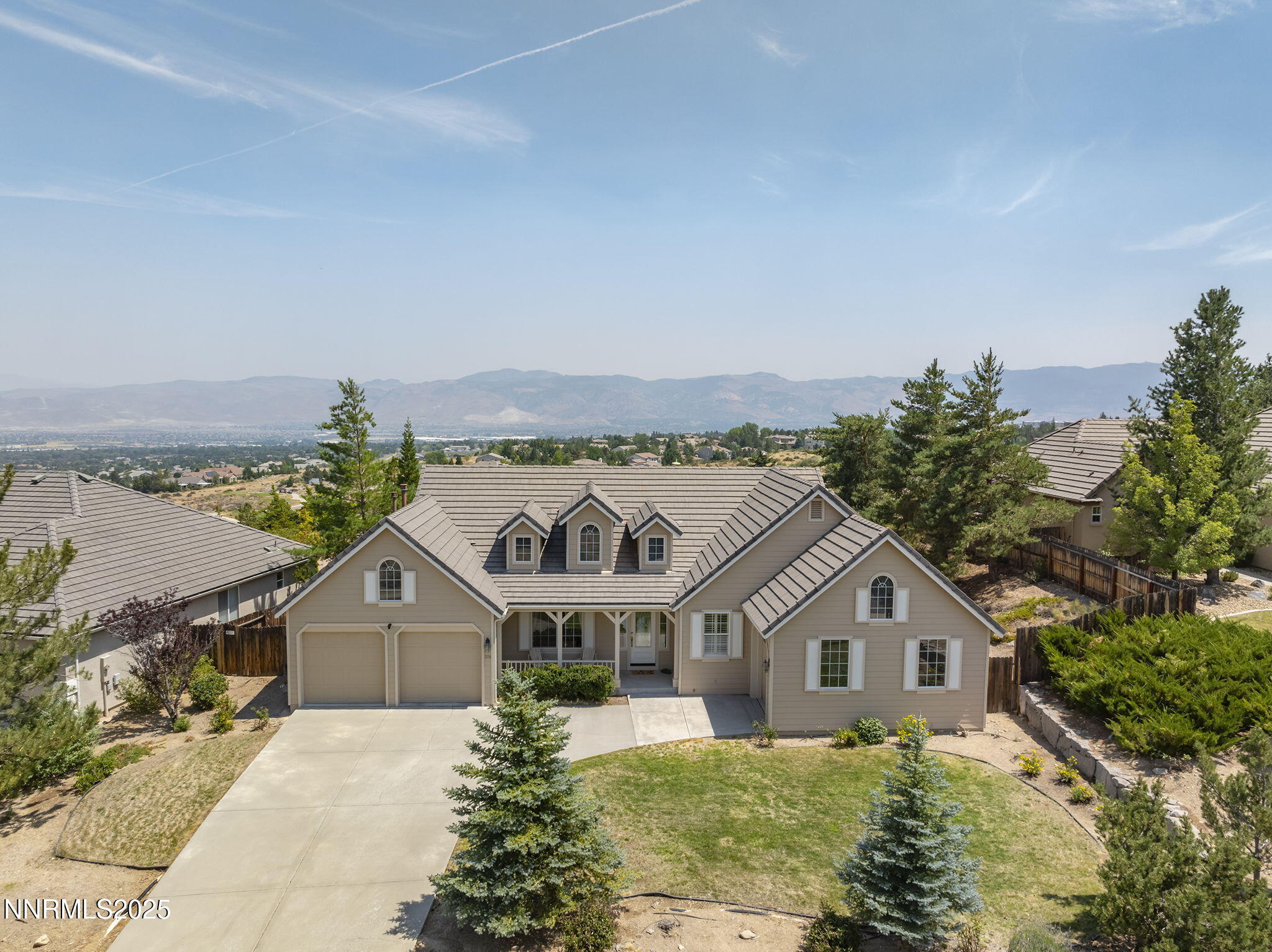 3206 Old Coach Court Reno, NV 89511 - Photo 2 of 40 a front view of a house with a yard and mountain view in back