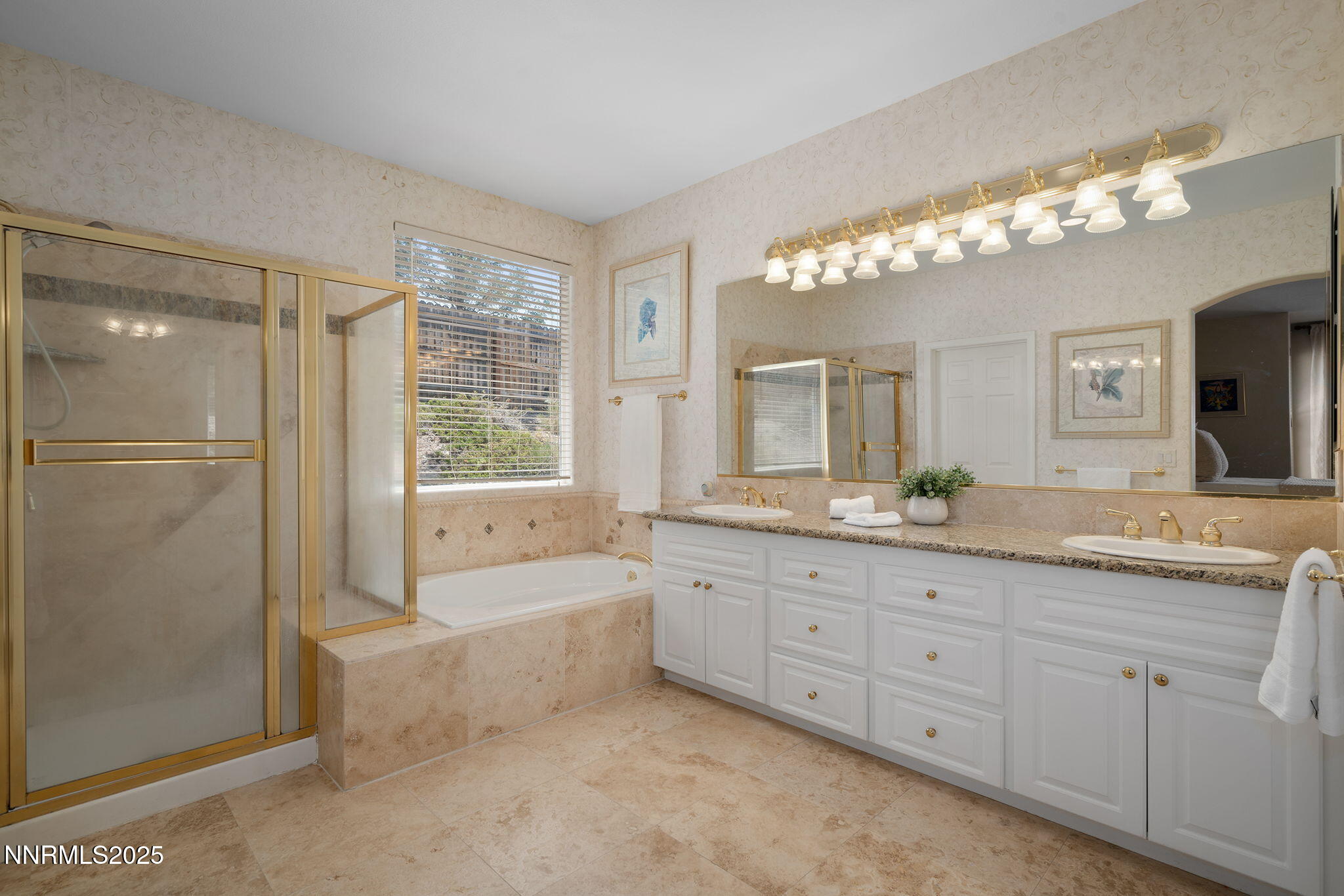 3206 Old Coach Court Reno, NV 89511 - Photo 25 of 40 a bathroom with a granite countertop sink a large mirror and a bathtub