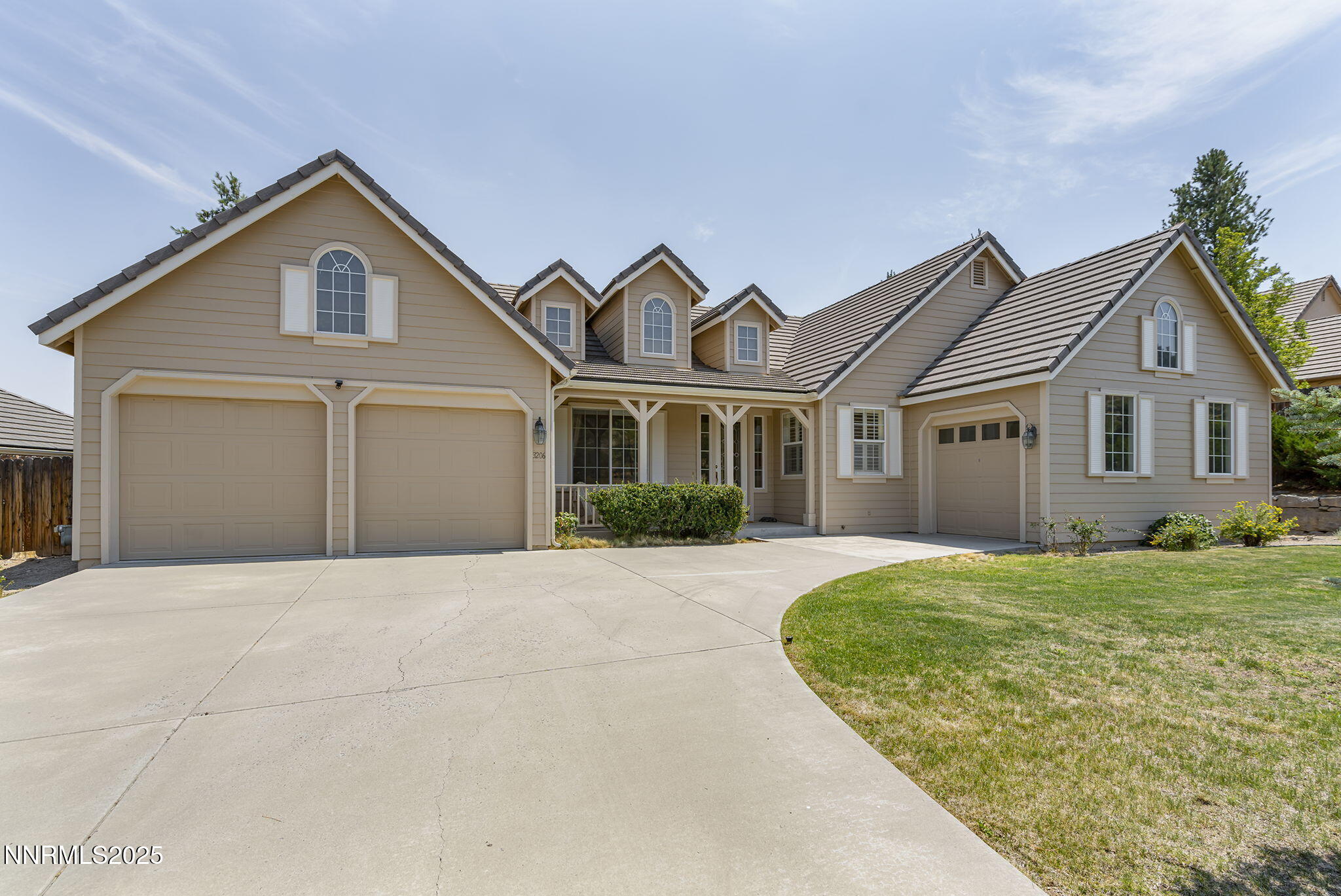 3206 Old Coach Court Reno, NV 89511 - Photo 3 of 40 a front view of a house with a yard and garage